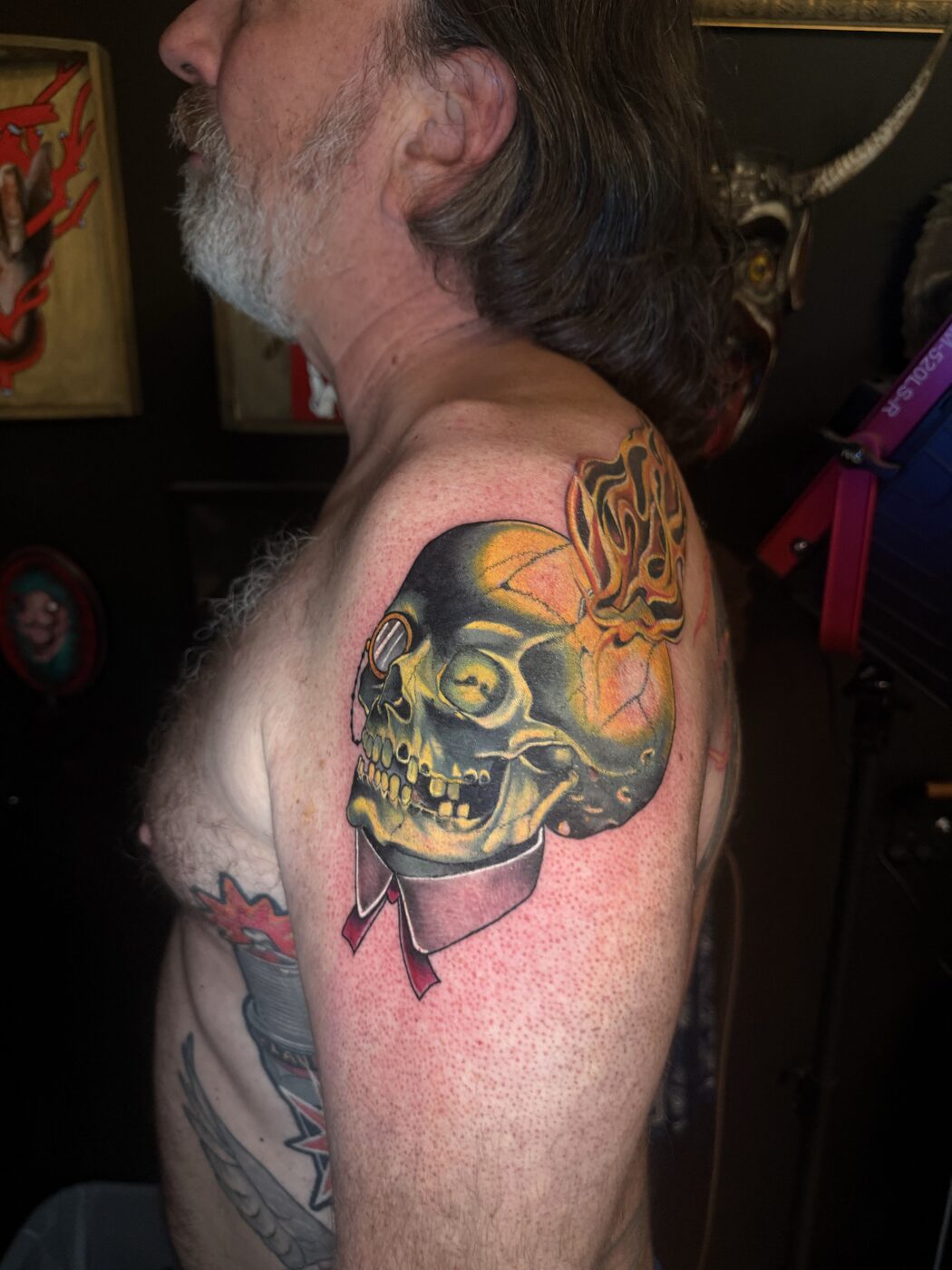 Green and gold flaming skull cover-up tattoo by Broken Art Tattoo, Los Angeles
