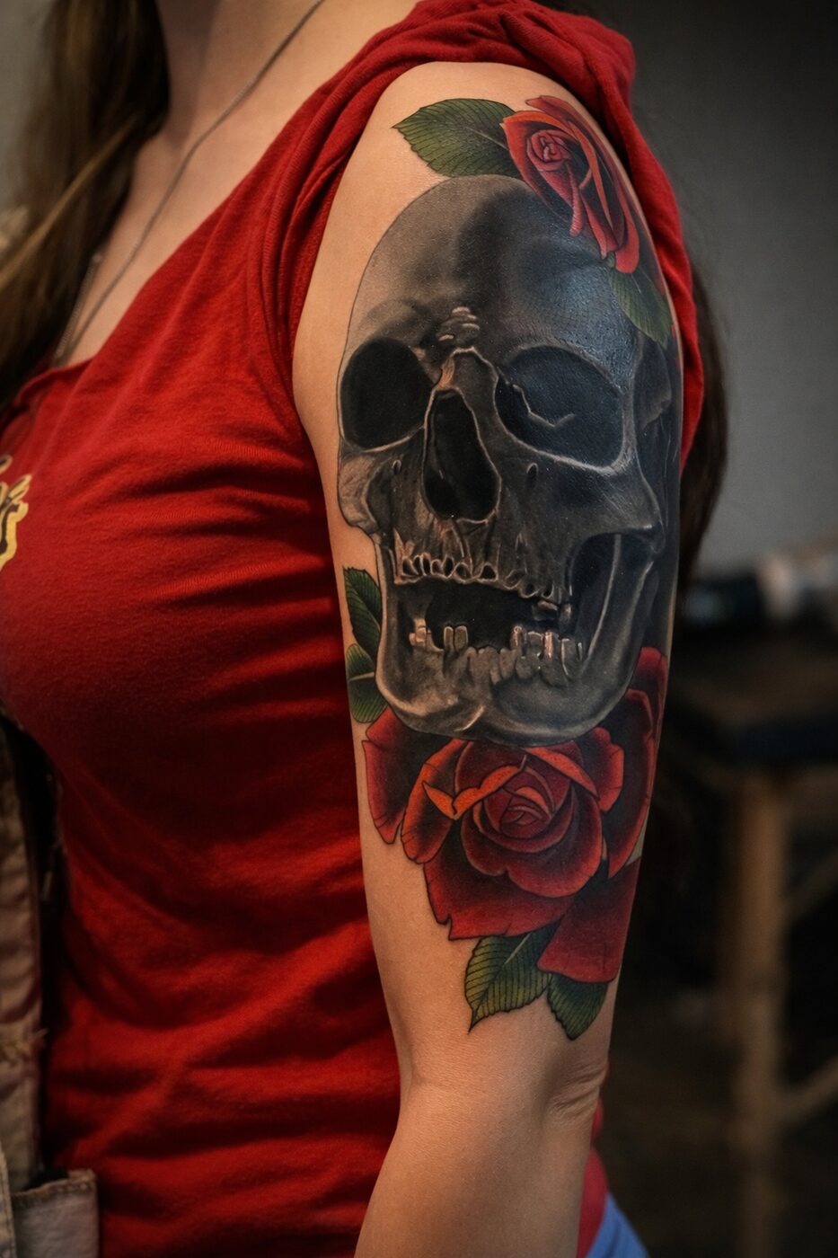 Realistic black skull and red roses cover-up tattoo by Broken Art Tattoo, Los Angeles
