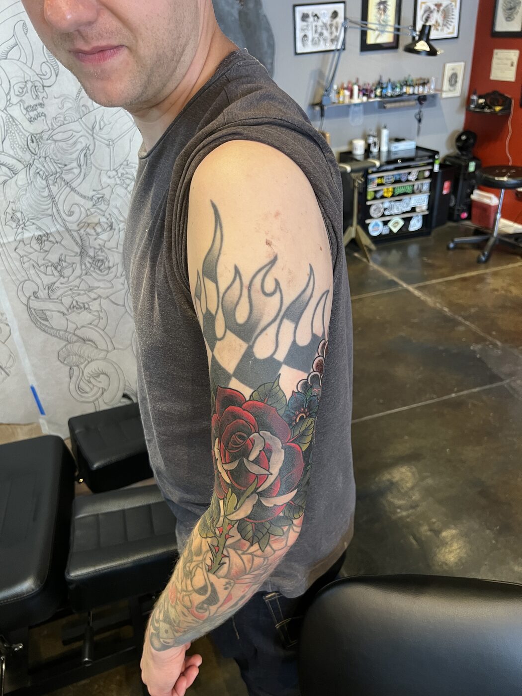 Older checkered-flame and rose sleeve before being reworked into a cover-up