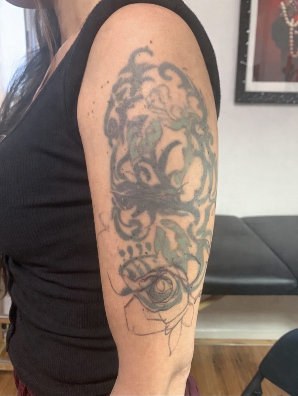 Faded old tattoo on the upper arm before a cover-up at Broken Art Tattoo